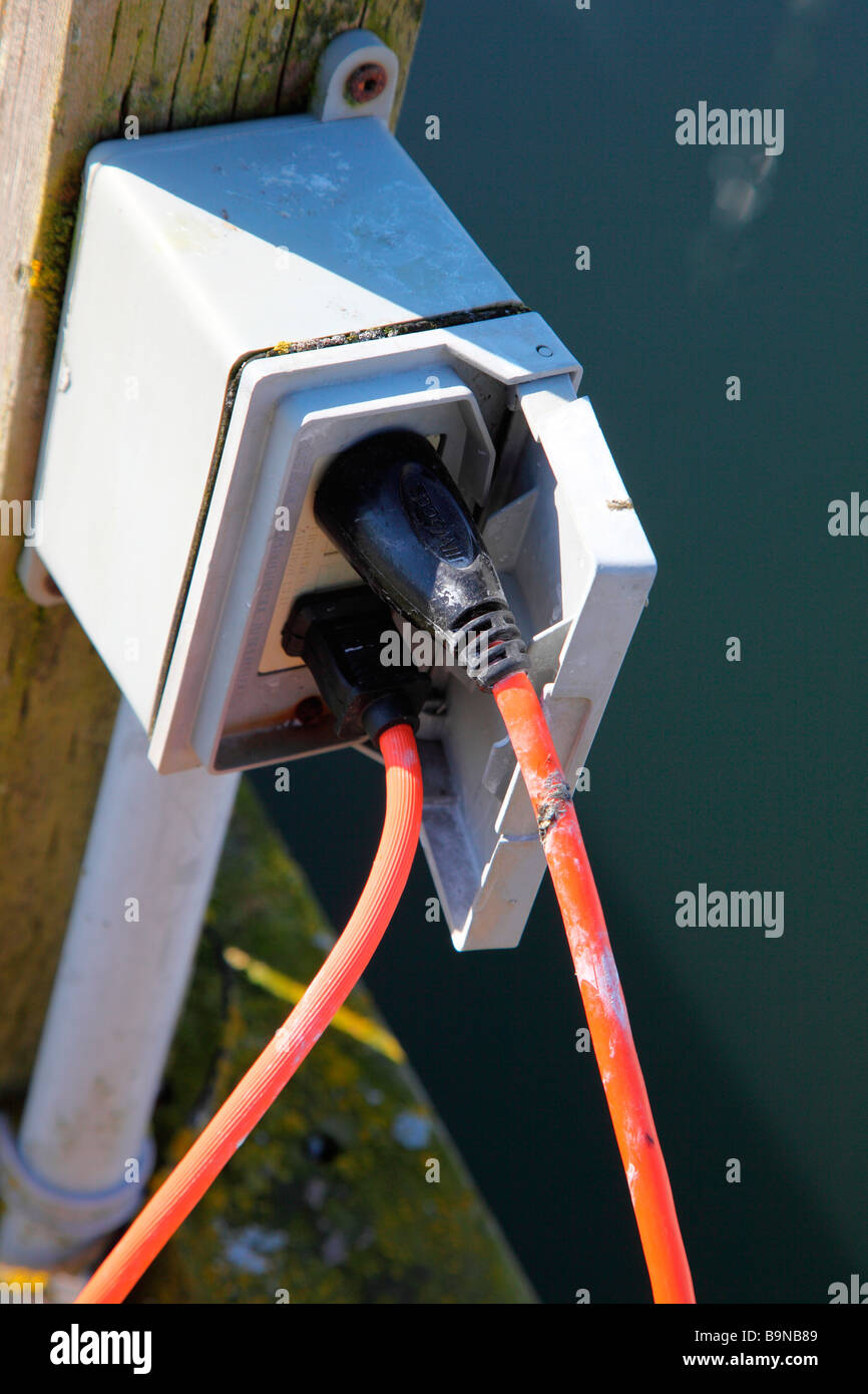 two power cords plugged in on a dock Stock Photo Alamy