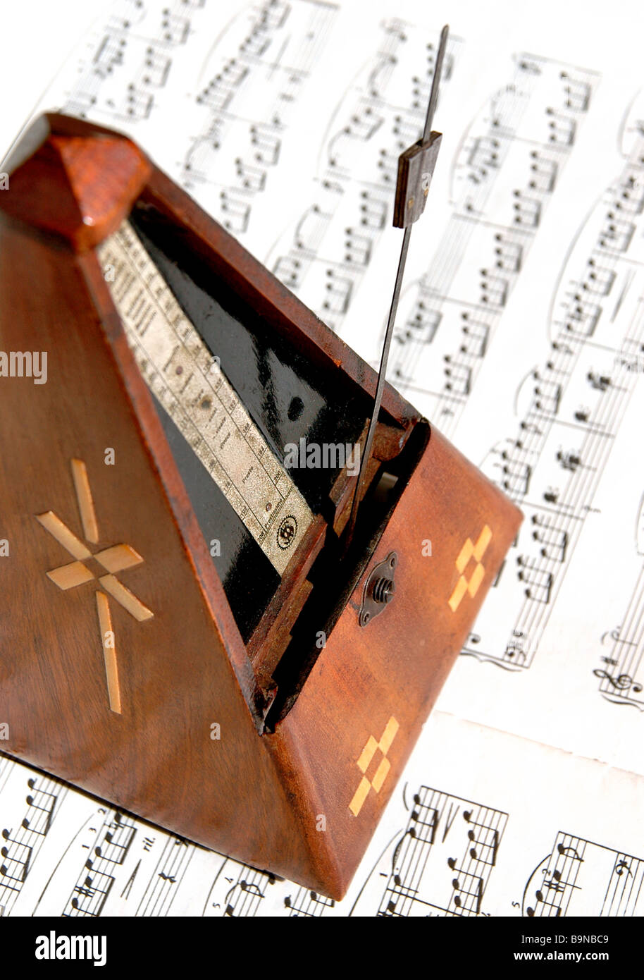 Old German metronome sits on top of sheet music Stock Photo Alamy