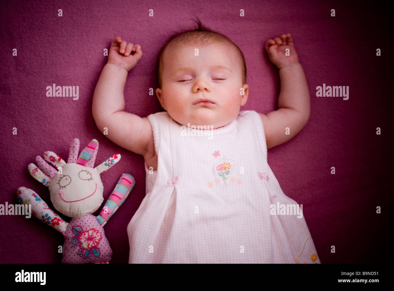 Baby sleeping with doll Stock Photo Alamy