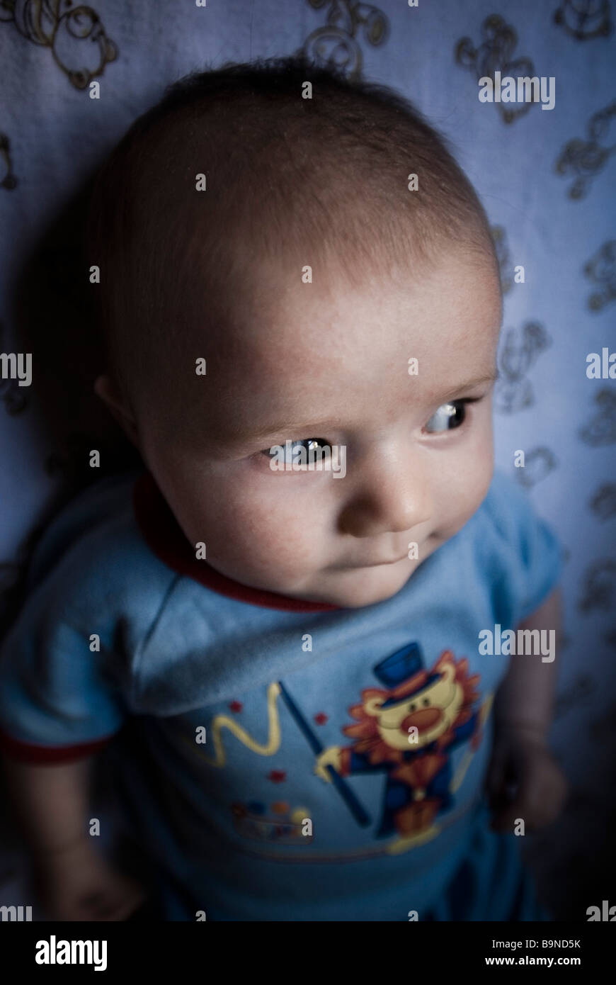 Baby boy looking out of cot Stock Photo Alamy