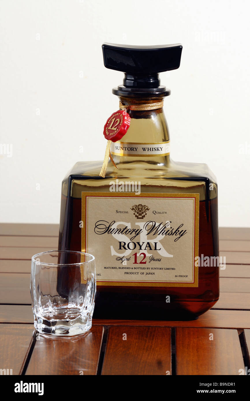 12 years old Suntory Whiskey - A bottle of Japanese Whisky with a glass on the table (Close up) isolated on white, cut-out. Stock Photo