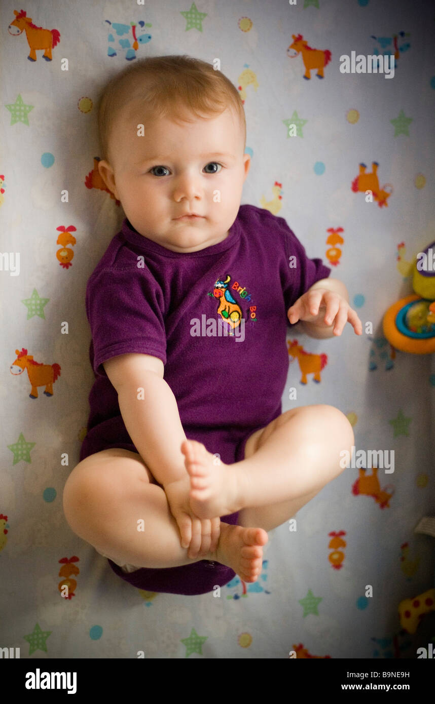 Baby lying in cot Stock Photo Alamy