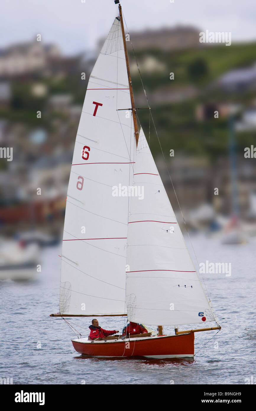 Troy class sailing boat in River Fowey estuary heads out to sea with