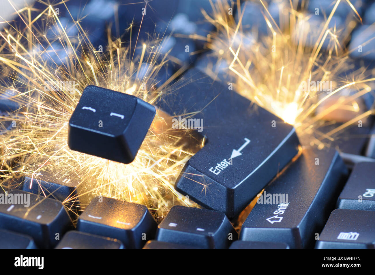 Black exploding computer keyboard with electric sparks. Stock Photo