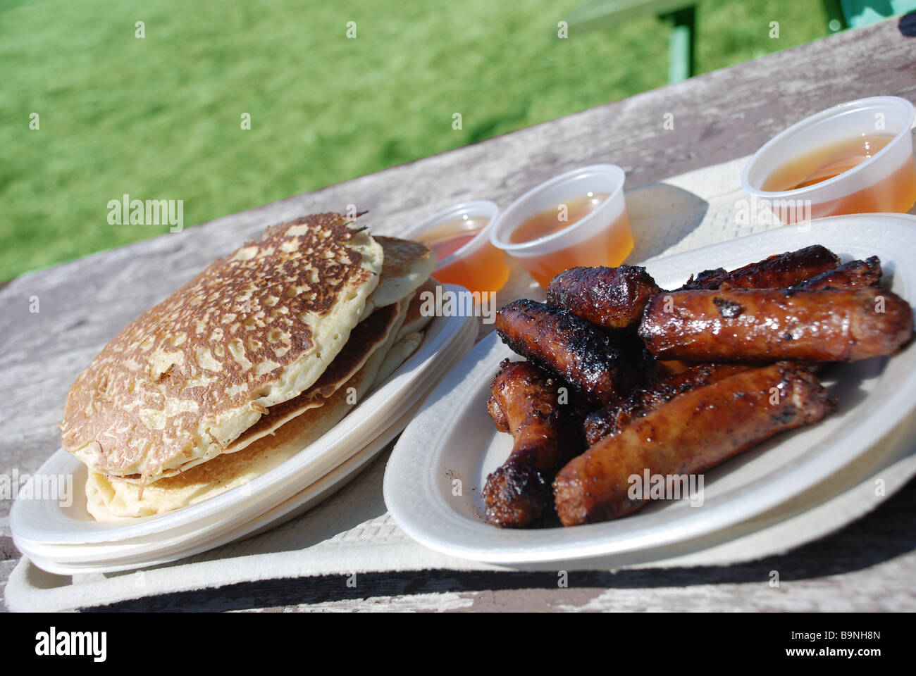 Breakfast with pancakes sausages and maple syrup Stock Photo