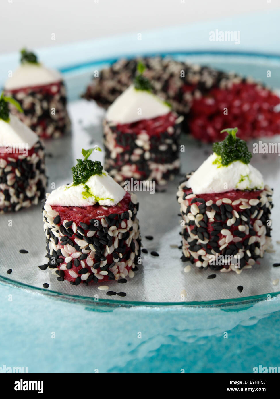 Beetroot risotto cakes with goats cheese and salsa verde Stock Photo