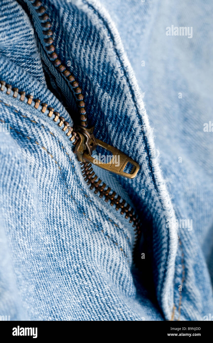 Macro of a brass zipper on blue jeans Stock Photo