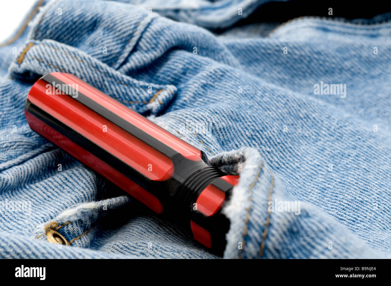 Red and black screwdriver in jeans pocket Stock Photo