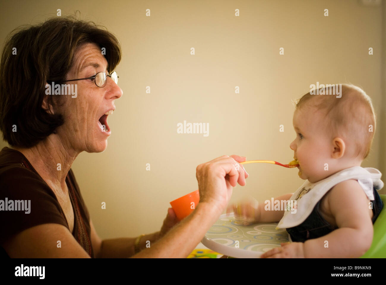Grandmother feeding baby Stock Photo