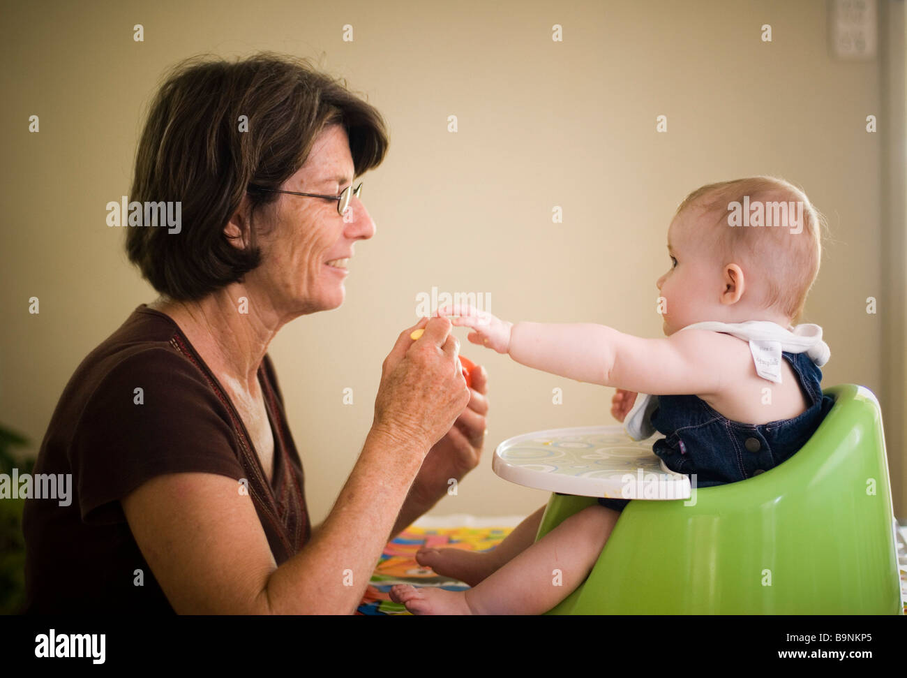 Grandmother feeding baby Stock Photo