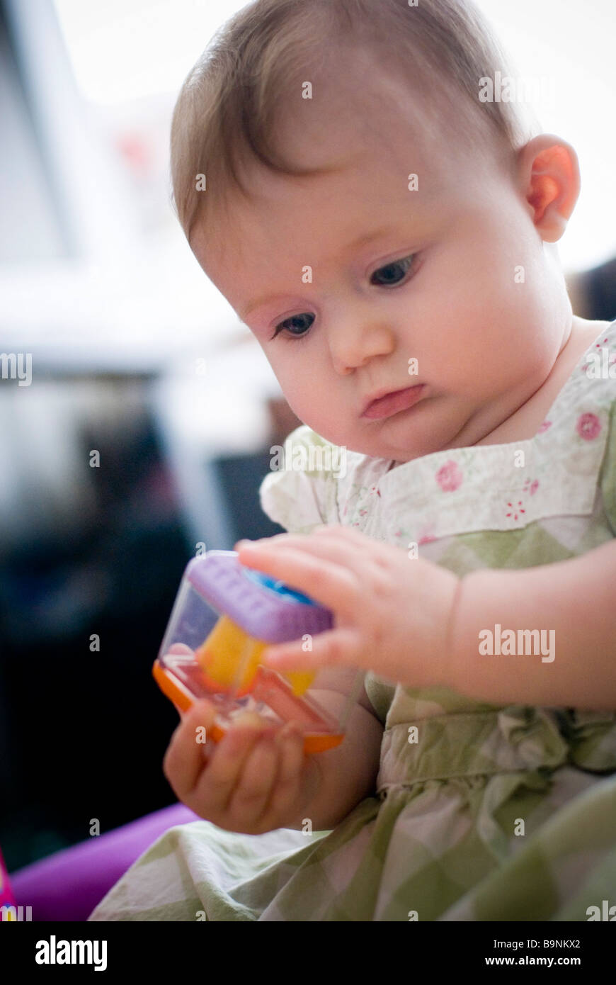 Baby girl playing with toy Stock Photo