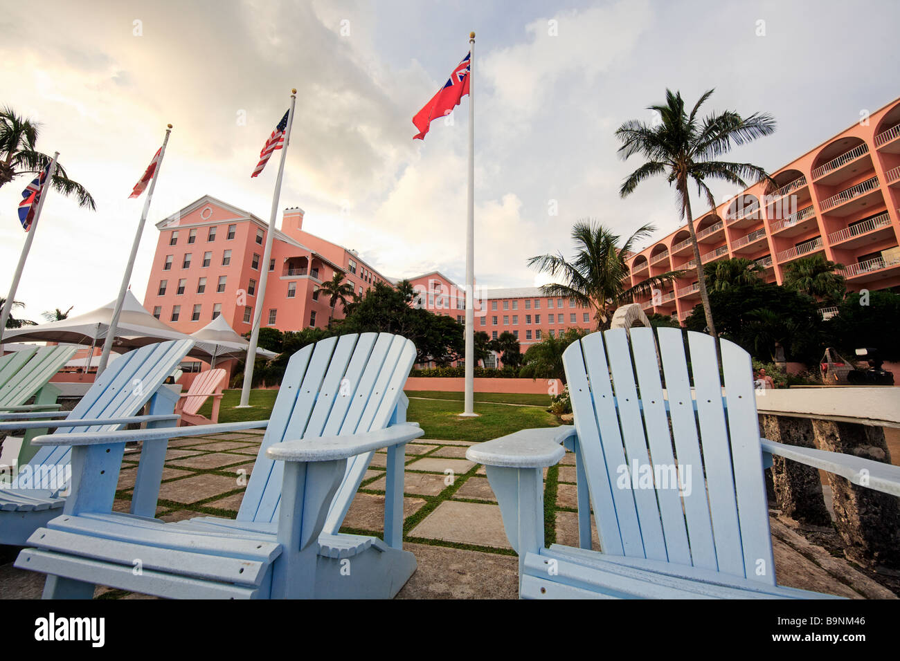Low Angle View of Adirondack Chairs With the Hamilton Princess Hotel Bermuda Stock Photo