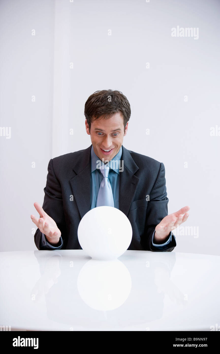 Businessman looking into crystal ball hi-res stock photography and ...