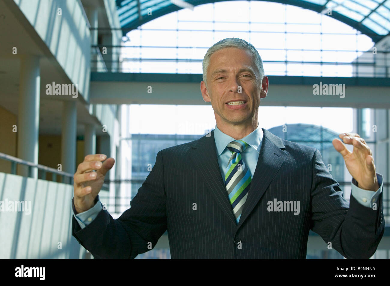 portrait of mature businessman making explanatory gesture Stock Photo