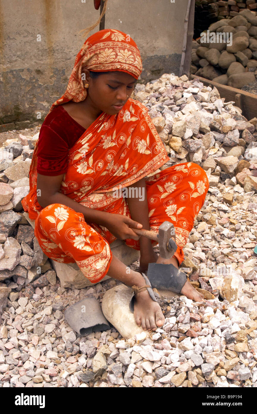 stone break breaker child labor asia poor cheap natural resource bangladesh poverty people struggle survival condition girl woma Stock Photo
