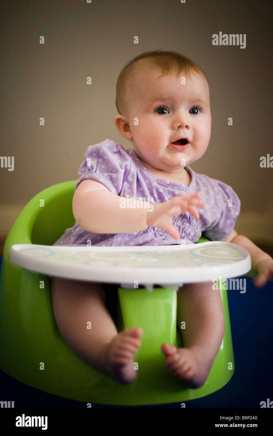 Baby girl in high chair Stock Photo Alamy