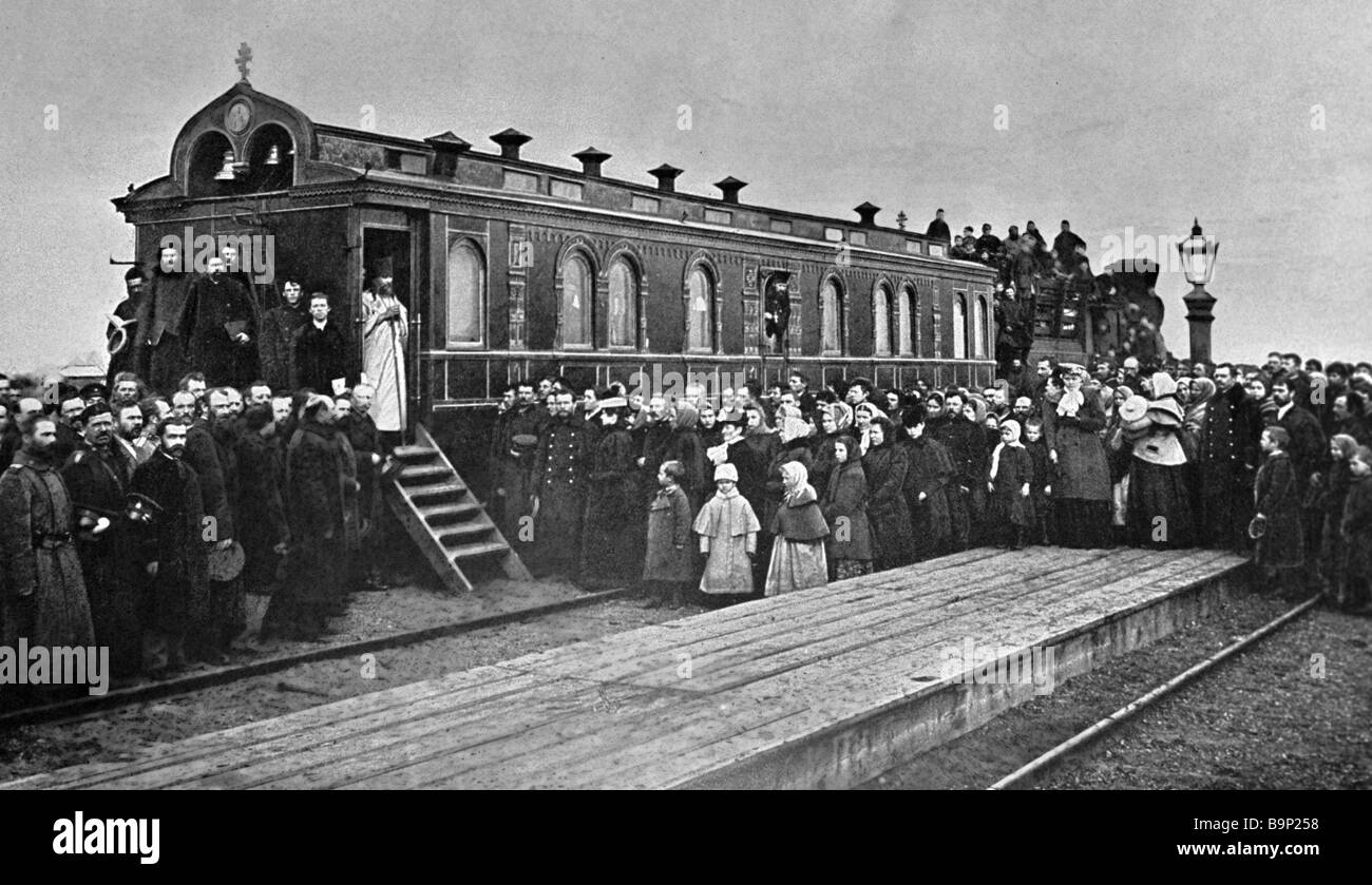 A clergyman beginning service near a railroad chapel car on the West ...