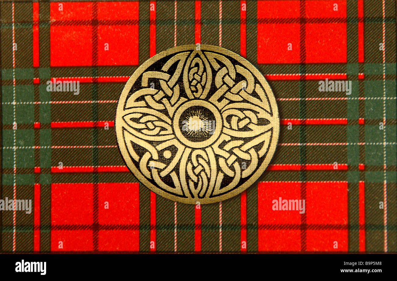Celtic brooch on red tartan. Stock Photo