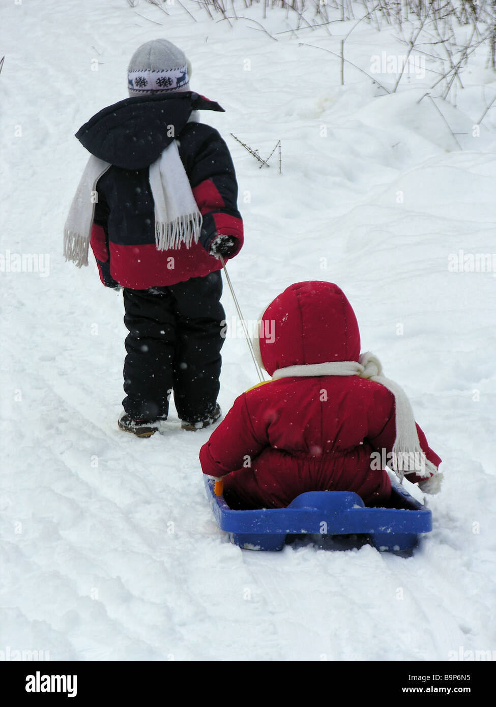 child with baby on sled Stock Photo - Alamy