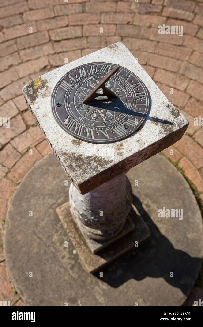 sundial on a sunny day against a brick pavement Stock Photo - Alamy