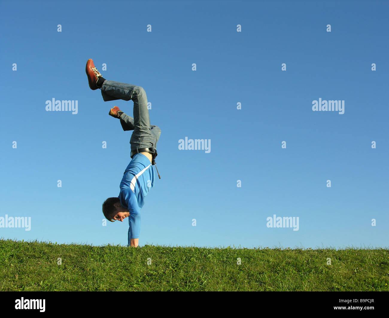 man on hands on blue sky Stock Photo - Alamy
