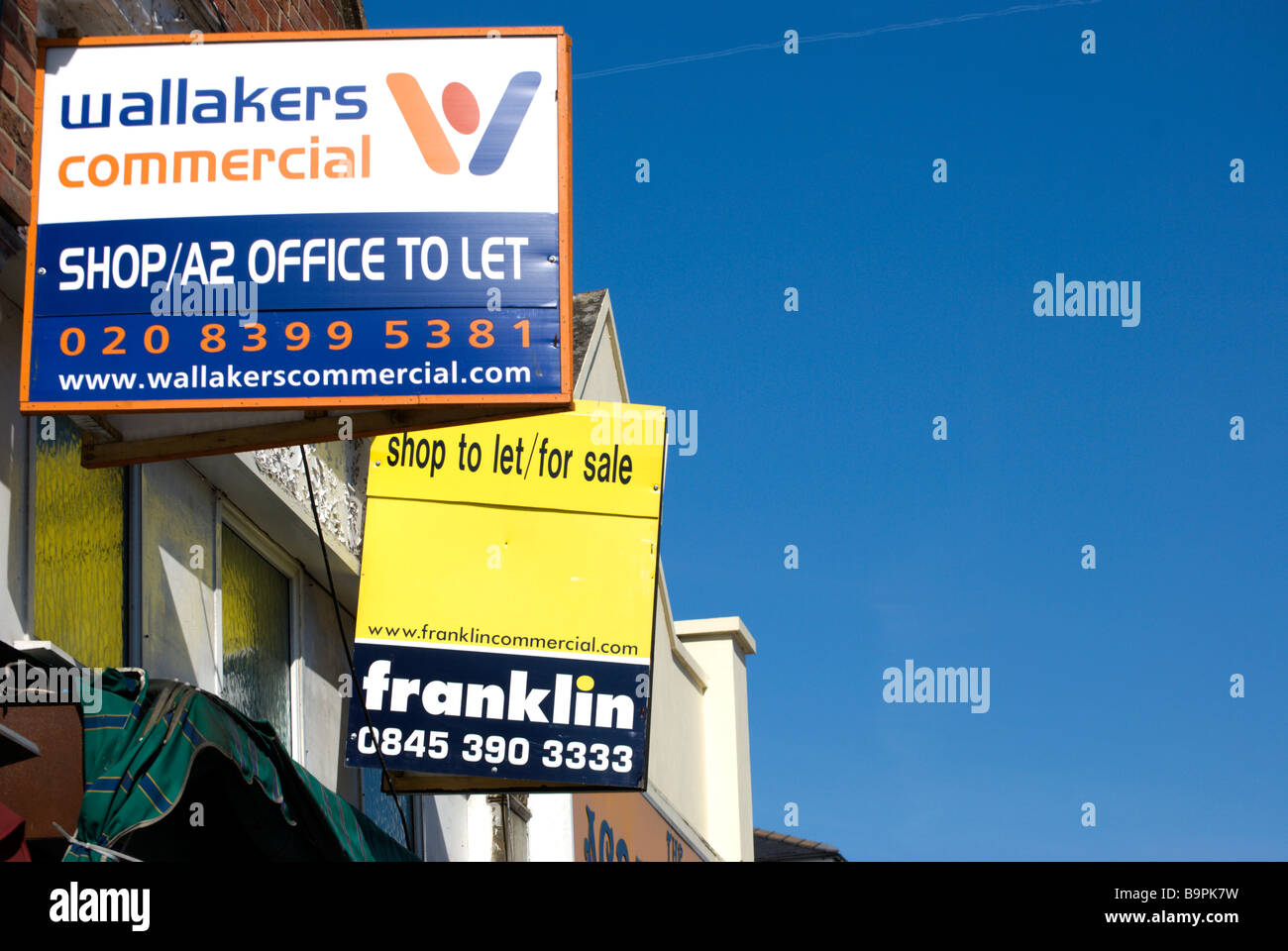 estate agents signs for flat to let and shop to let Stock Photo