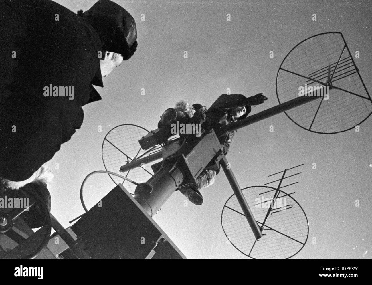 Radio engineers at the Soviet North Pole station mounting a direction