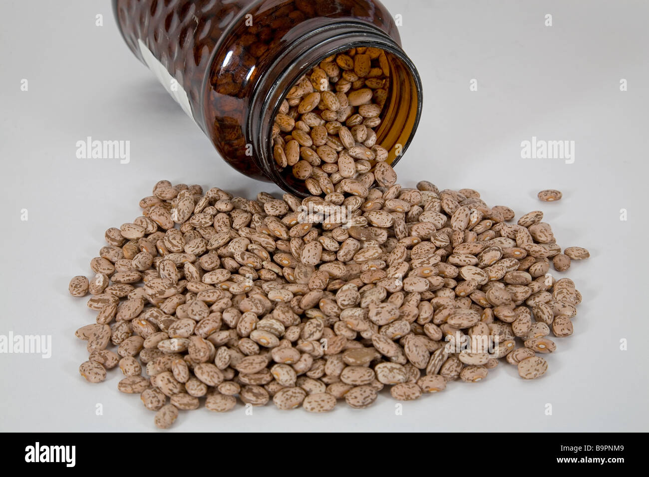 Beans pinto beans lentils legume being stored in a jar Stock Photo