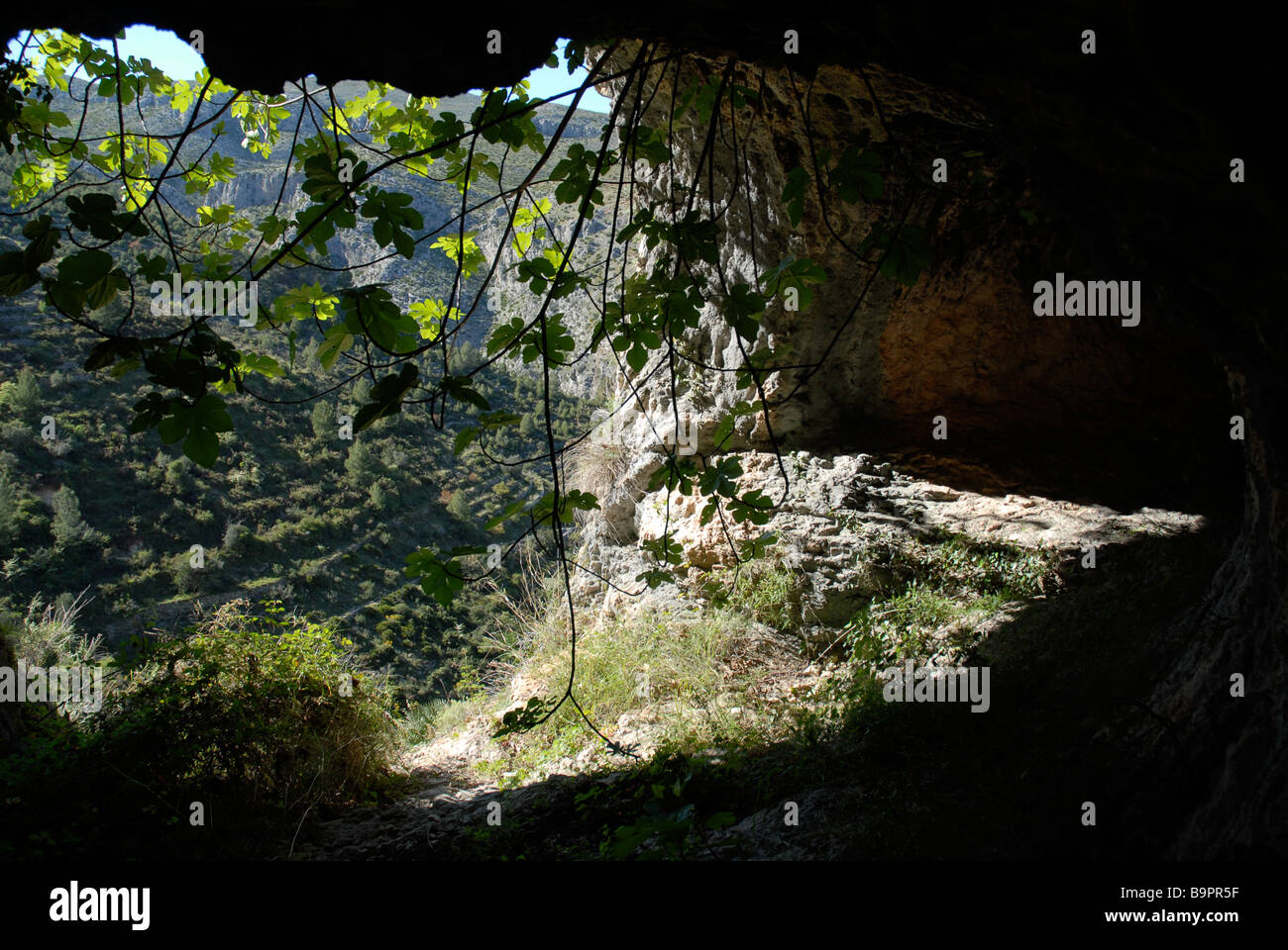 looking out of a cave, on a Mozarabic trail, Vall de Laguart, Benimaurell, Alicante Province, Comunidad Valenciana, Spain Stock Photo