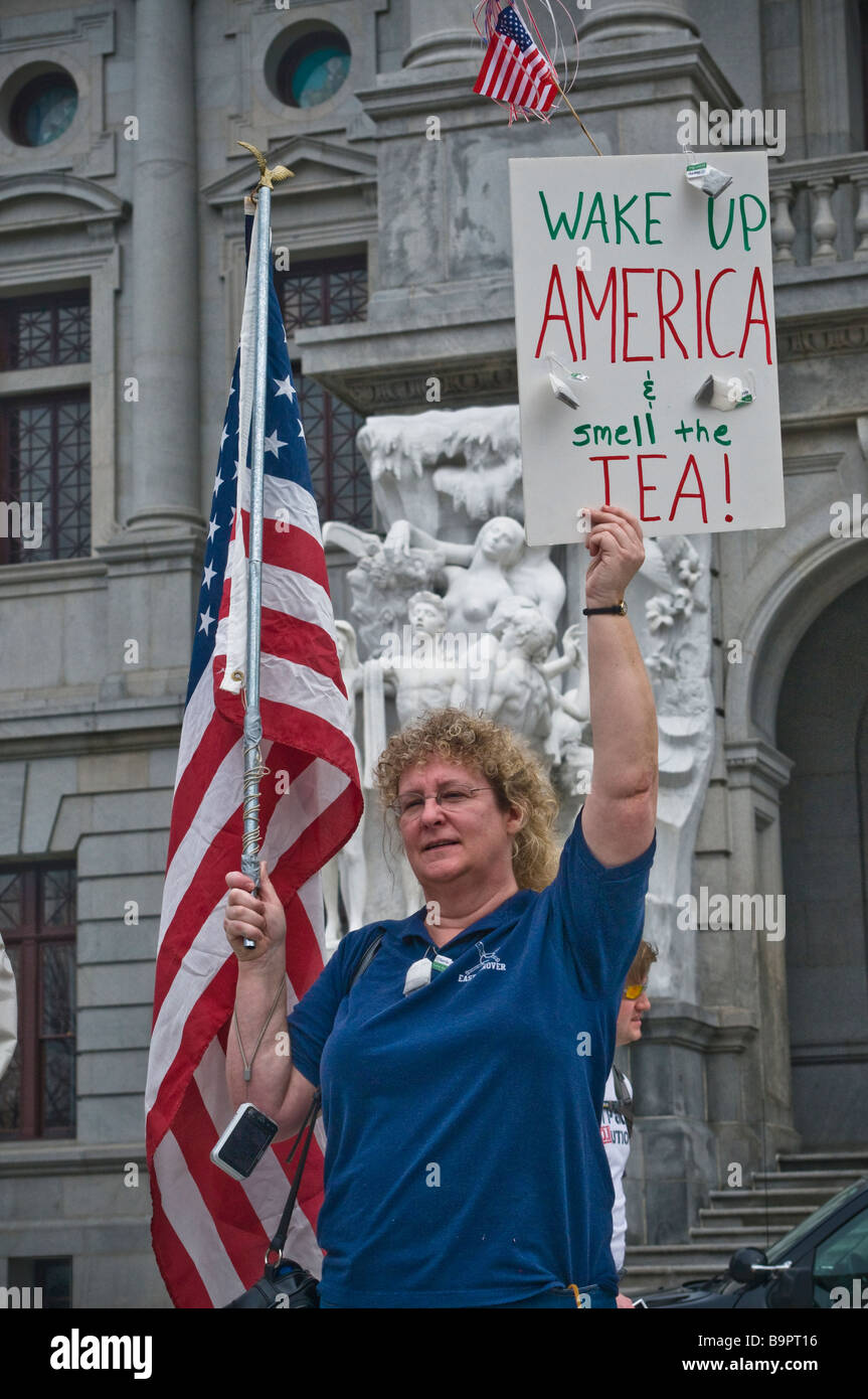 anti spending tax protest tea party Harrisburg PA , demonstrator, wqake up America smell the tea sign USA flag Stock Photo