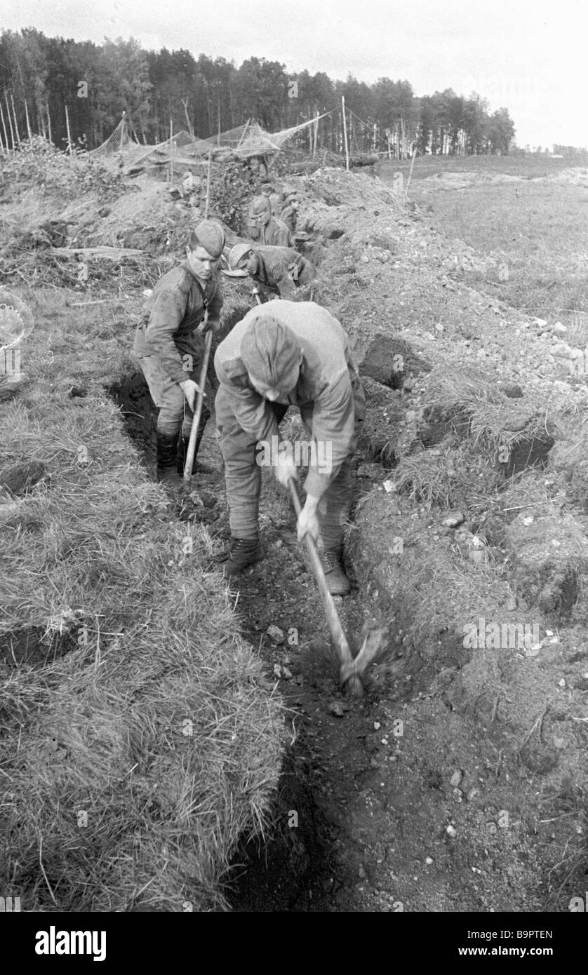 Artillerymen digging trenches Stock Photo