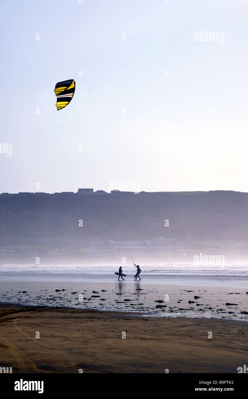 Pair of kite surfers carrying boards Stock Photo