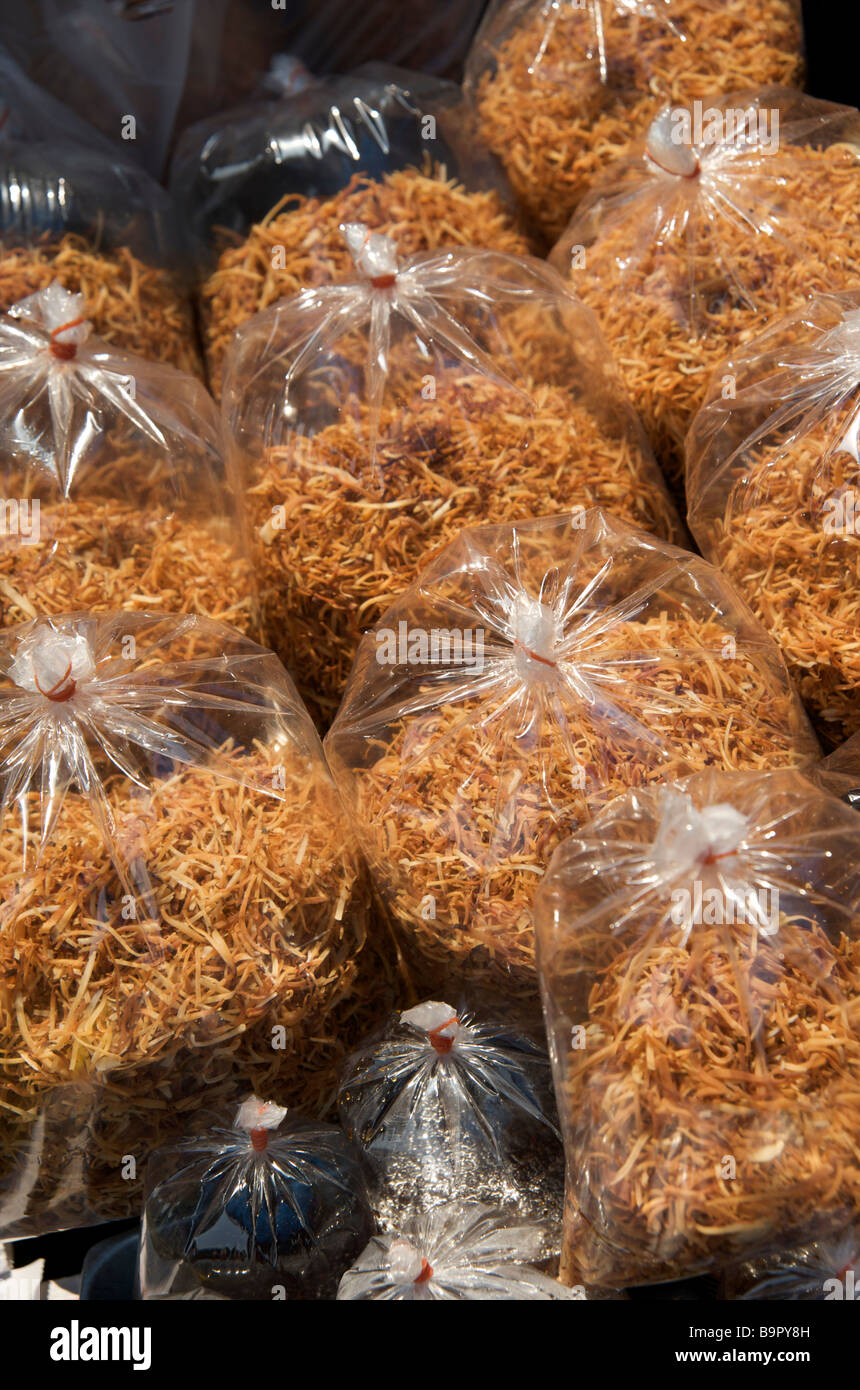 A close up of dried ginger bagged in takeaway portions on a Bangkok street stall Thailand Stock Photo