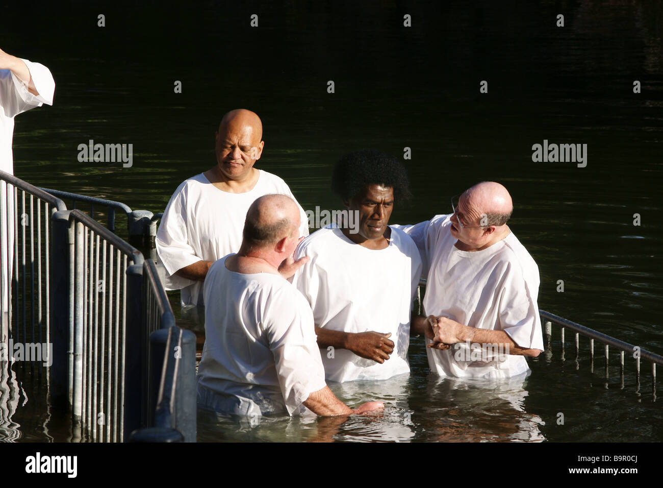 Israel Yardenit Baptismal Site In the Jordan River Near the Sea of Galilee A group of pilgrims being Baptized Stock Photo