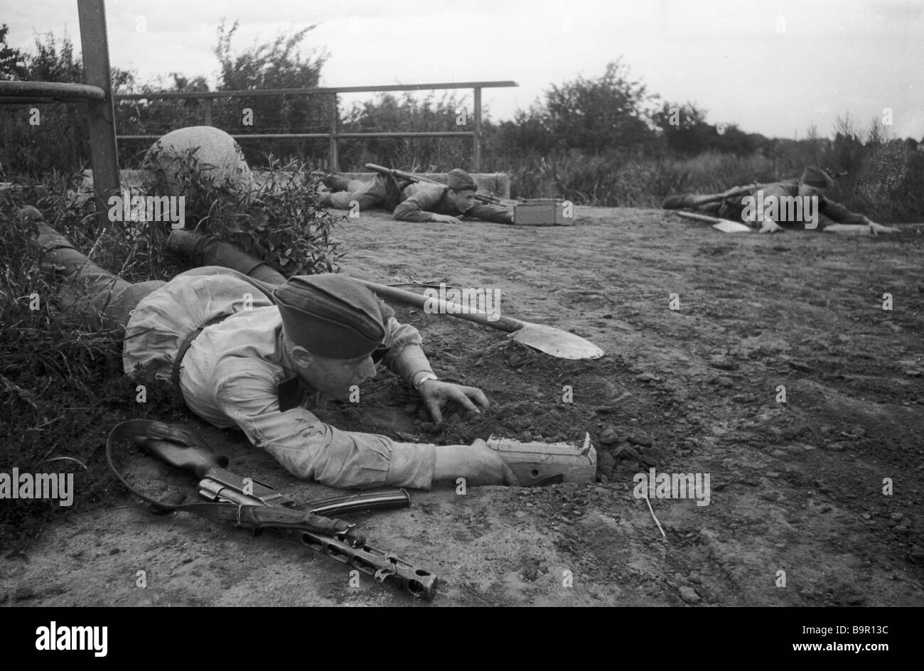 Soviet combat engineers laying mines on the approaches to the bridge ...