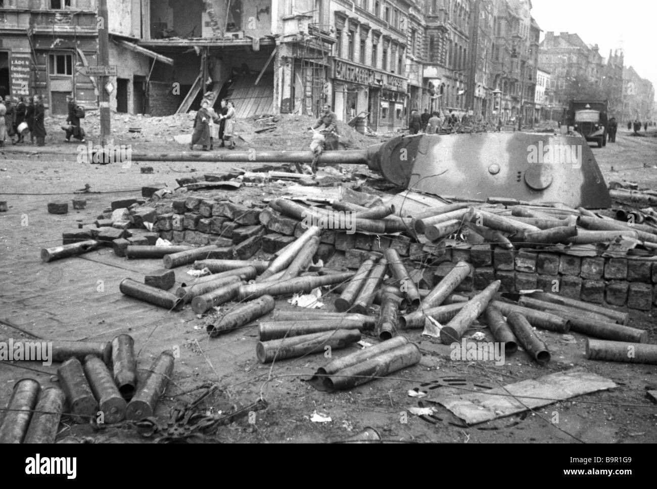 Soviet artillery hits a German tank earthed in one of Berlin streets
