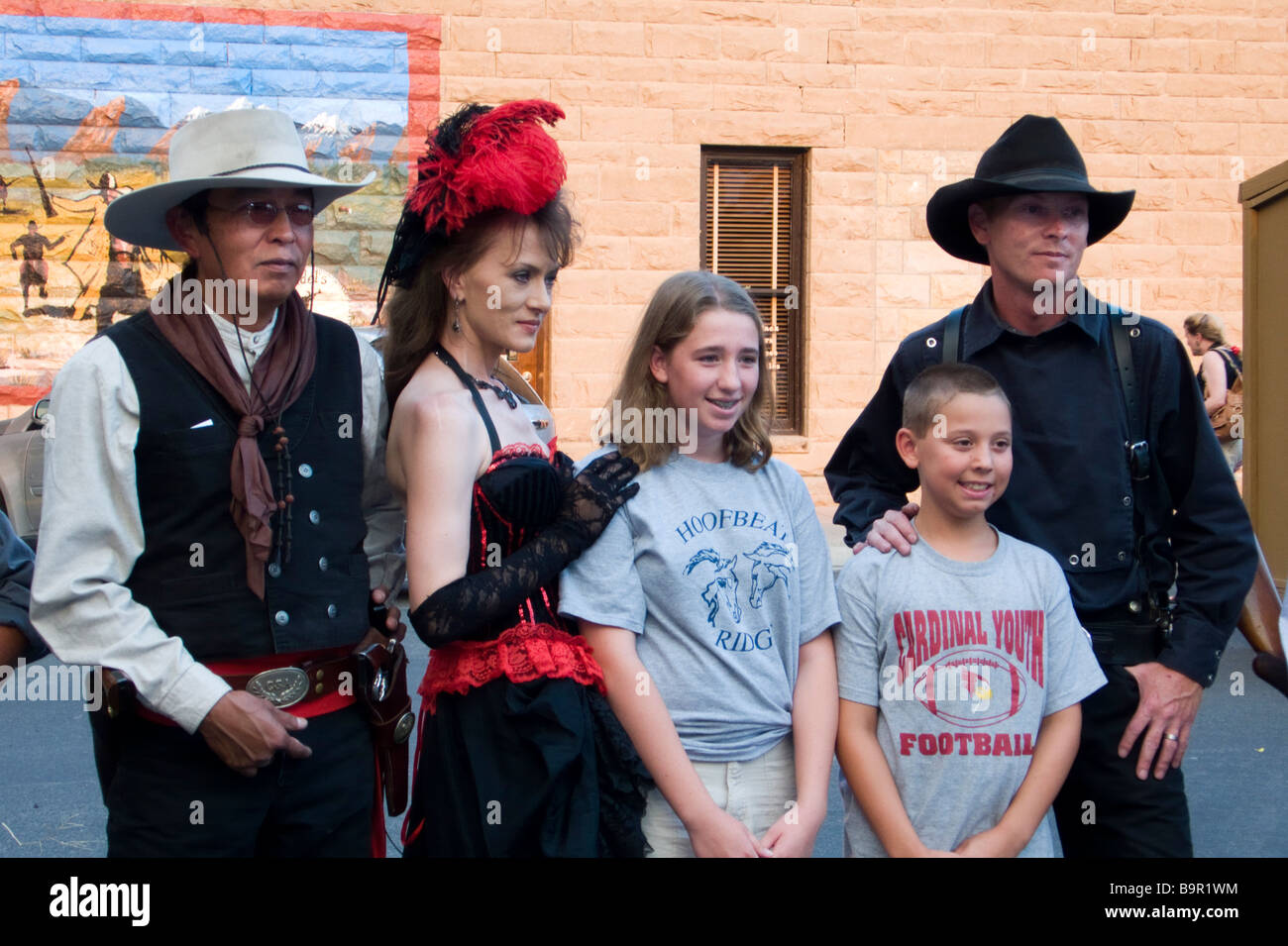 Youngsters pose with actors gunfight re-enactment outside Irma Hotel Cody Wyoming USA Stock Photo