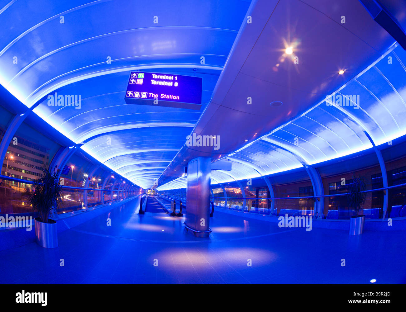 Manchester Airport UK the passenger connection walkways with travelators at night Stock Photo