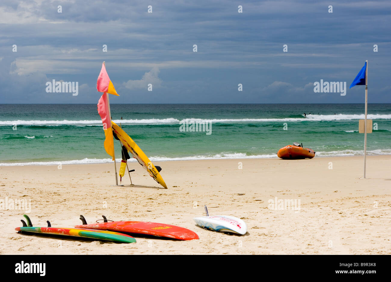 Empty beach with surfboards and lifeboat. Stock Photo