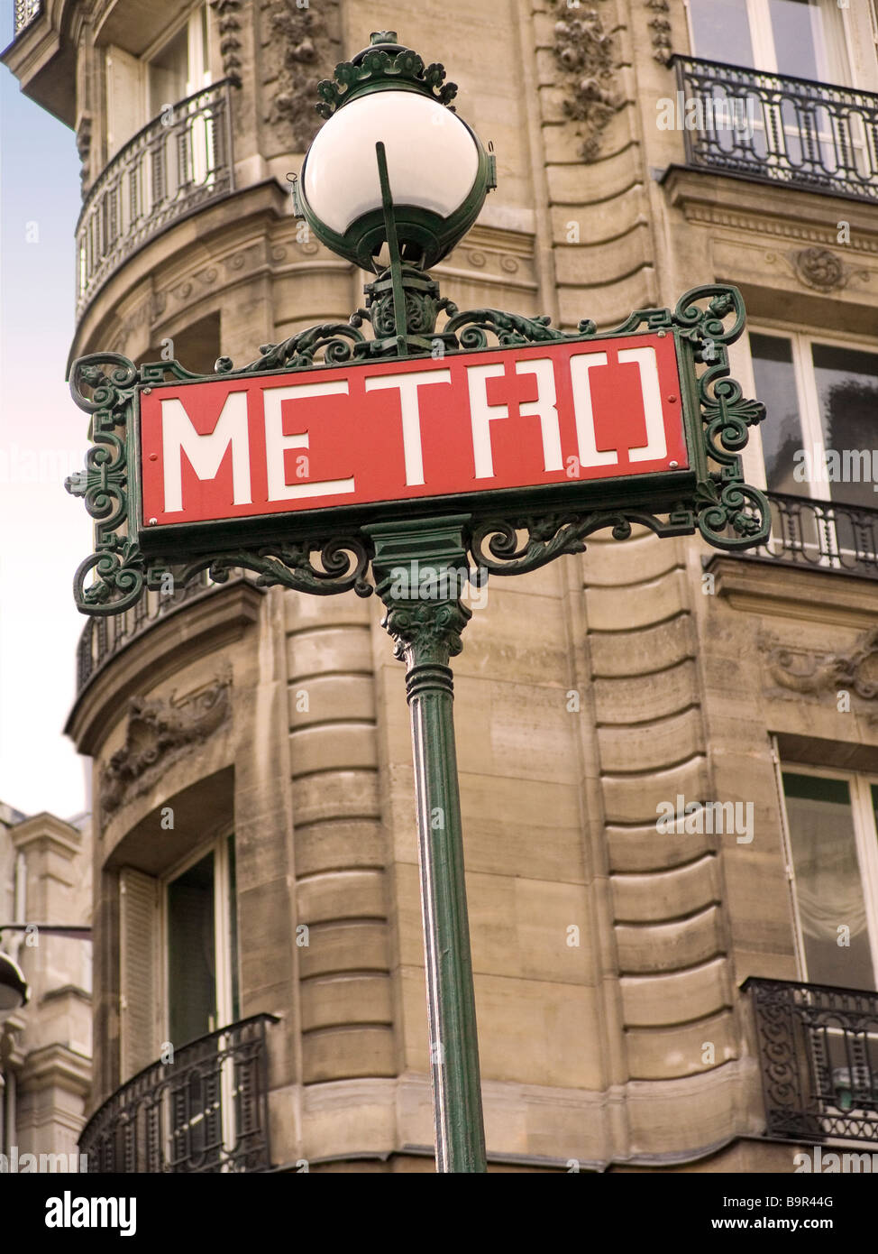 Iconic Metro underground sign with building in the background, Paris France Stock Photo