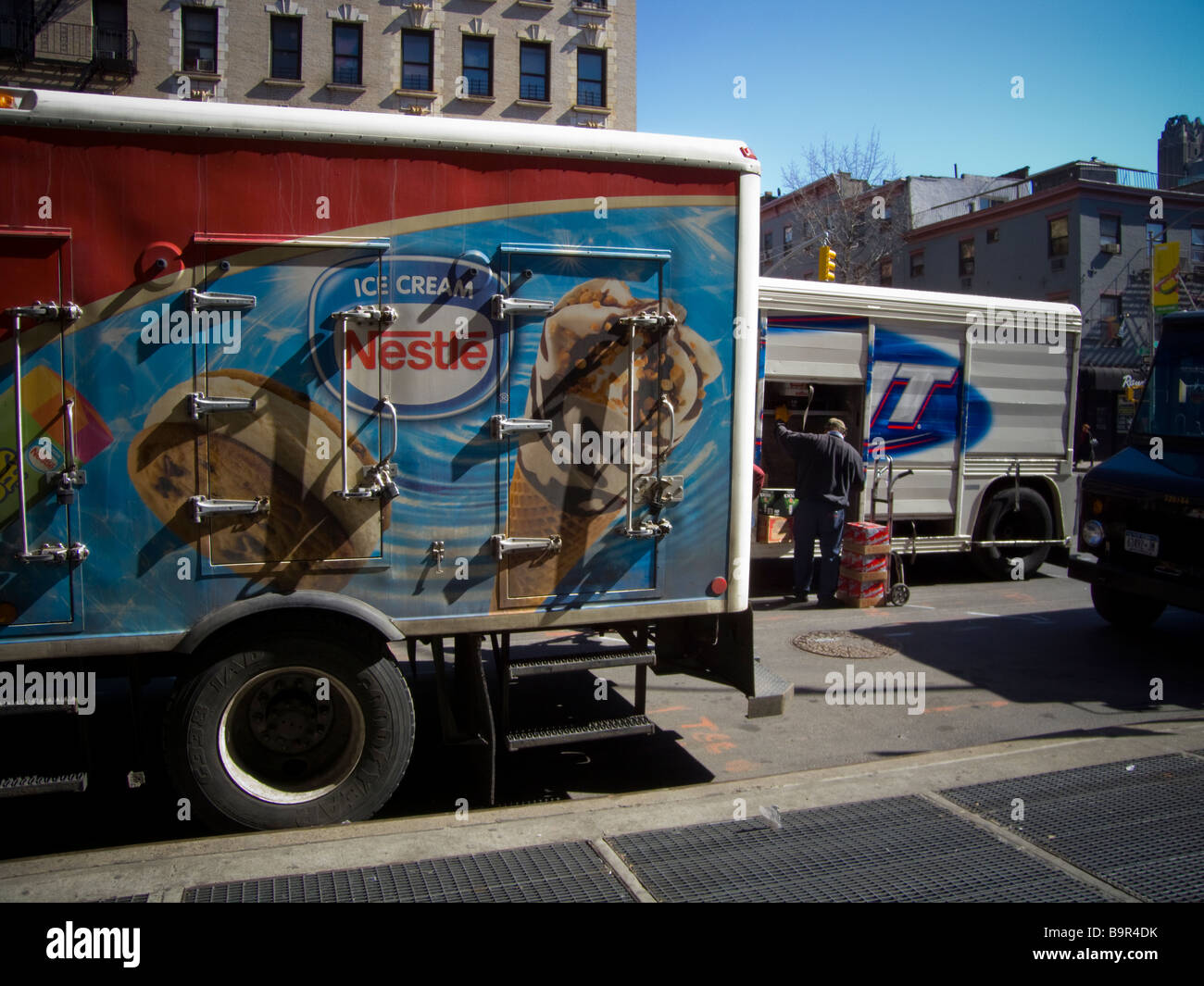 Delivery trucks parked in front of a supermarket in the Chelsea