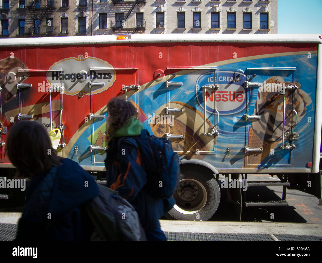 Ice cream delivery trucks parked in front of a supermarket in the Chelsea neighborhood of New York Stock Photo