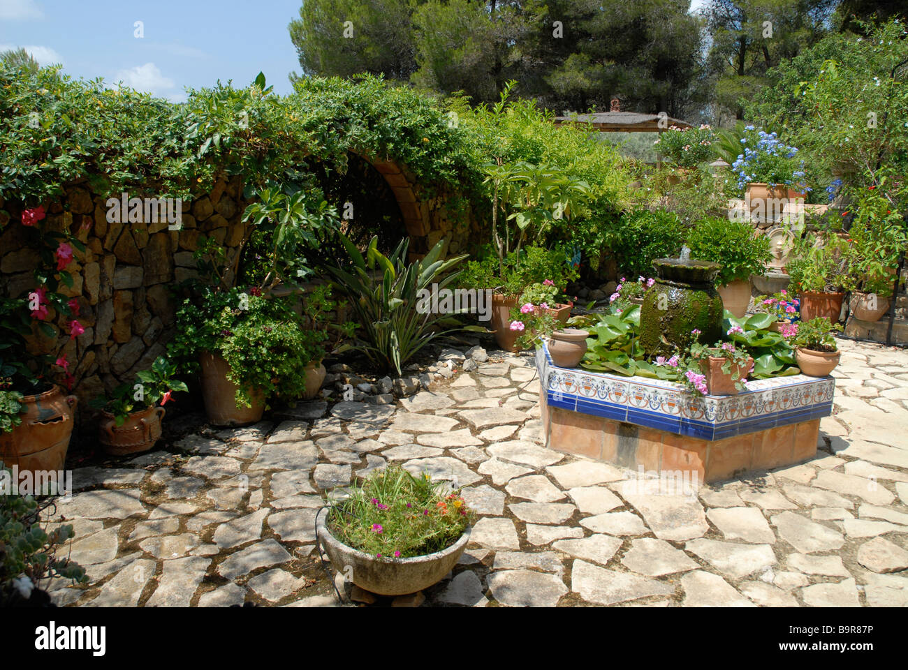 typical Spanish walled courtyard garden with raised pond, Jesus Pobre