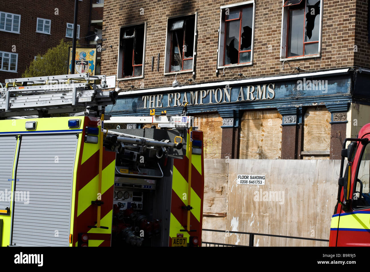 Ladder uk fire engine uk burnt out building Stock Photo