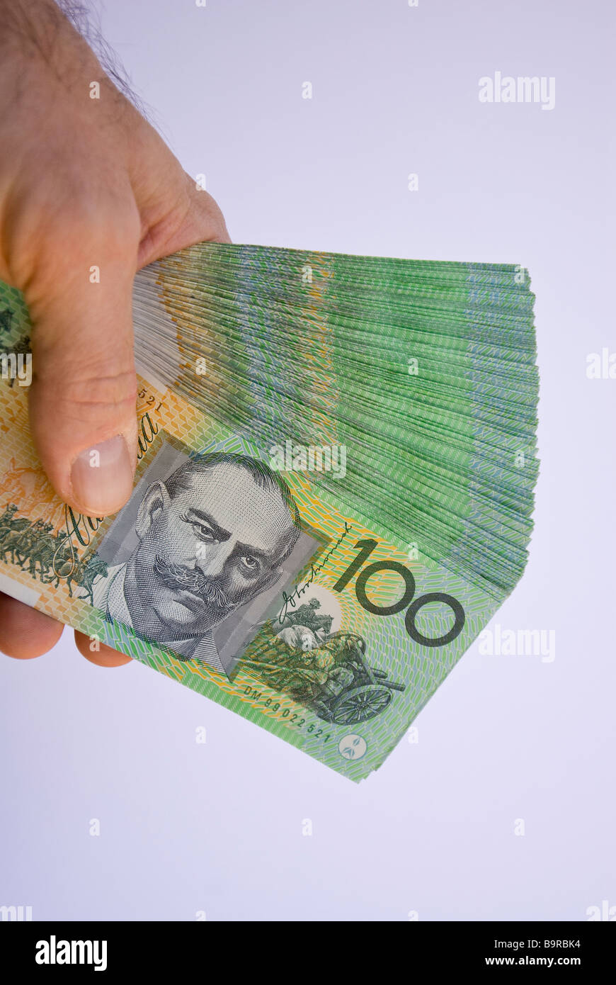 A fan of A$20,000 $20,000 twenty thousand Australian dollars in a hand Stock Photo - Alamy