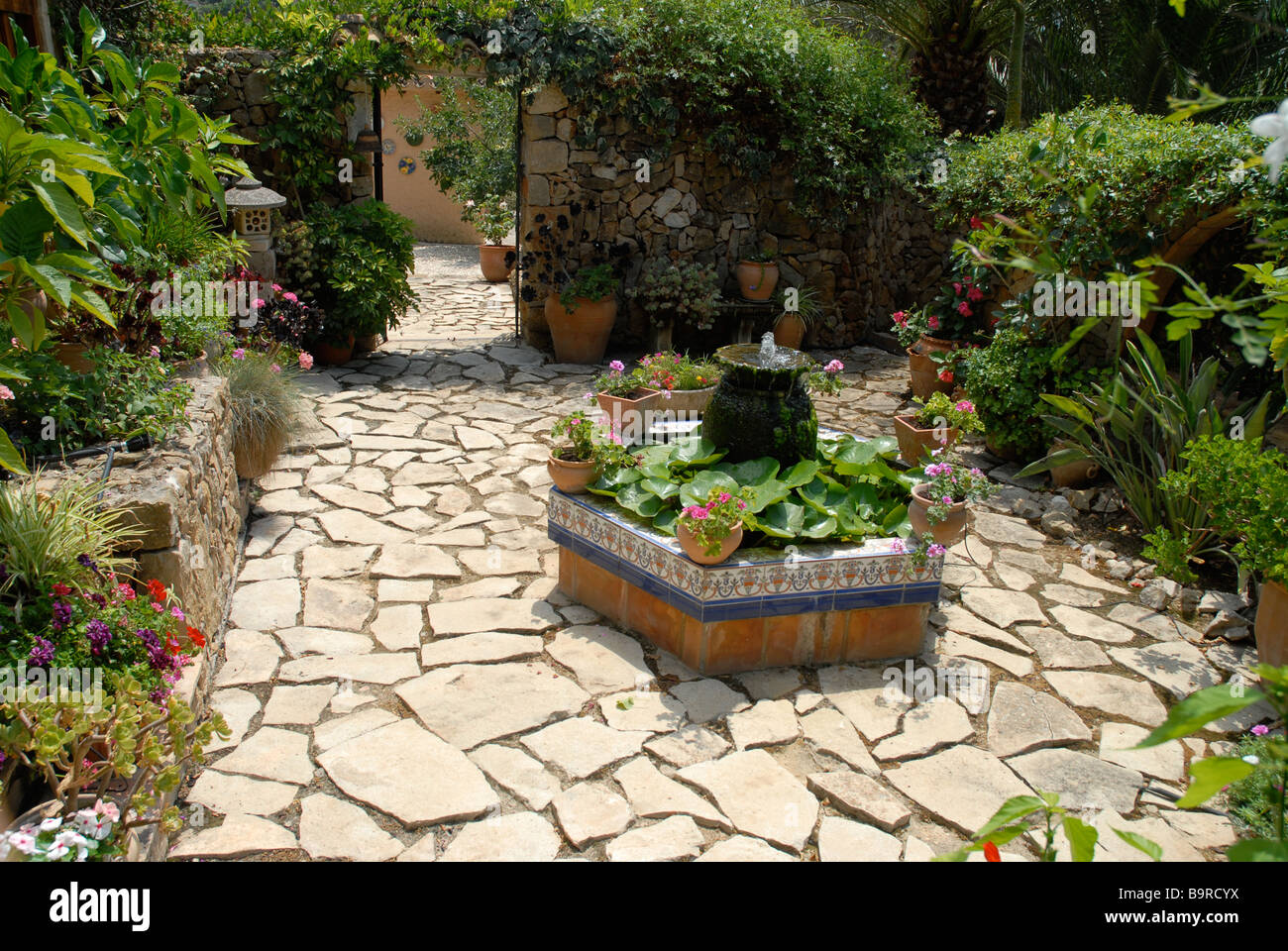 Typical Spanish Walled Courtyard Garden With Pond And Water