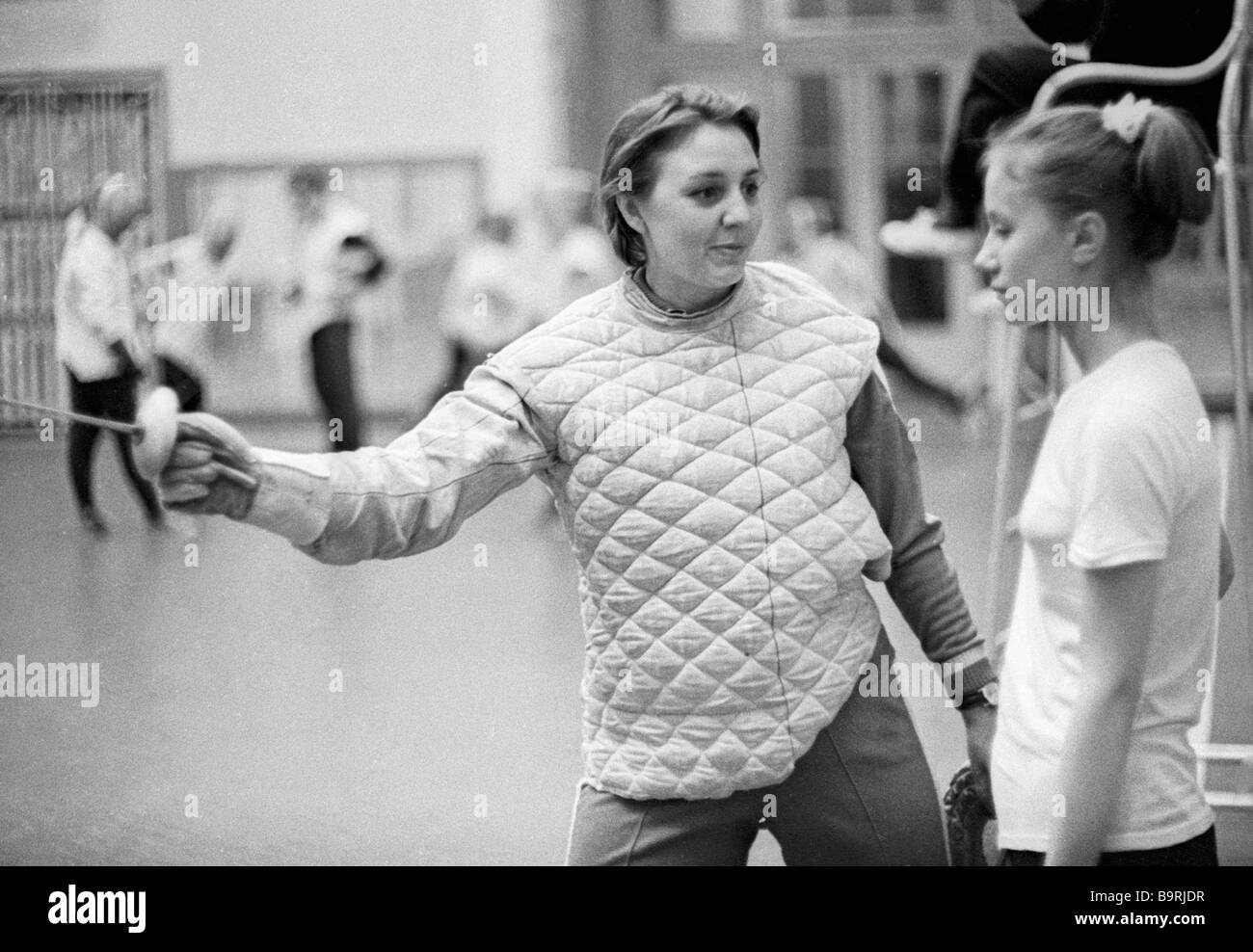 Fencing coach instructing his trainee Stock Photo Alamy