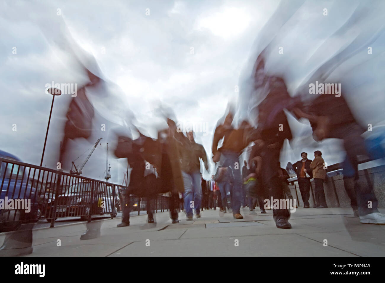 Commuters in the rush hour crossing London Bridge Stock Photo