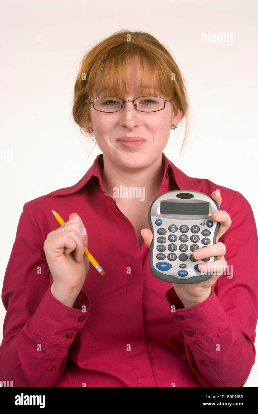 A woman has just made a calculation on a calculator and seems pleased with the result Stock Photo
