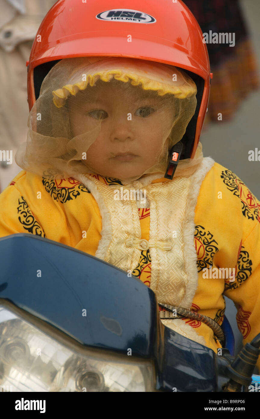baby on a motorcycle at the Hmong minority market in Sapa Vietnam Stock